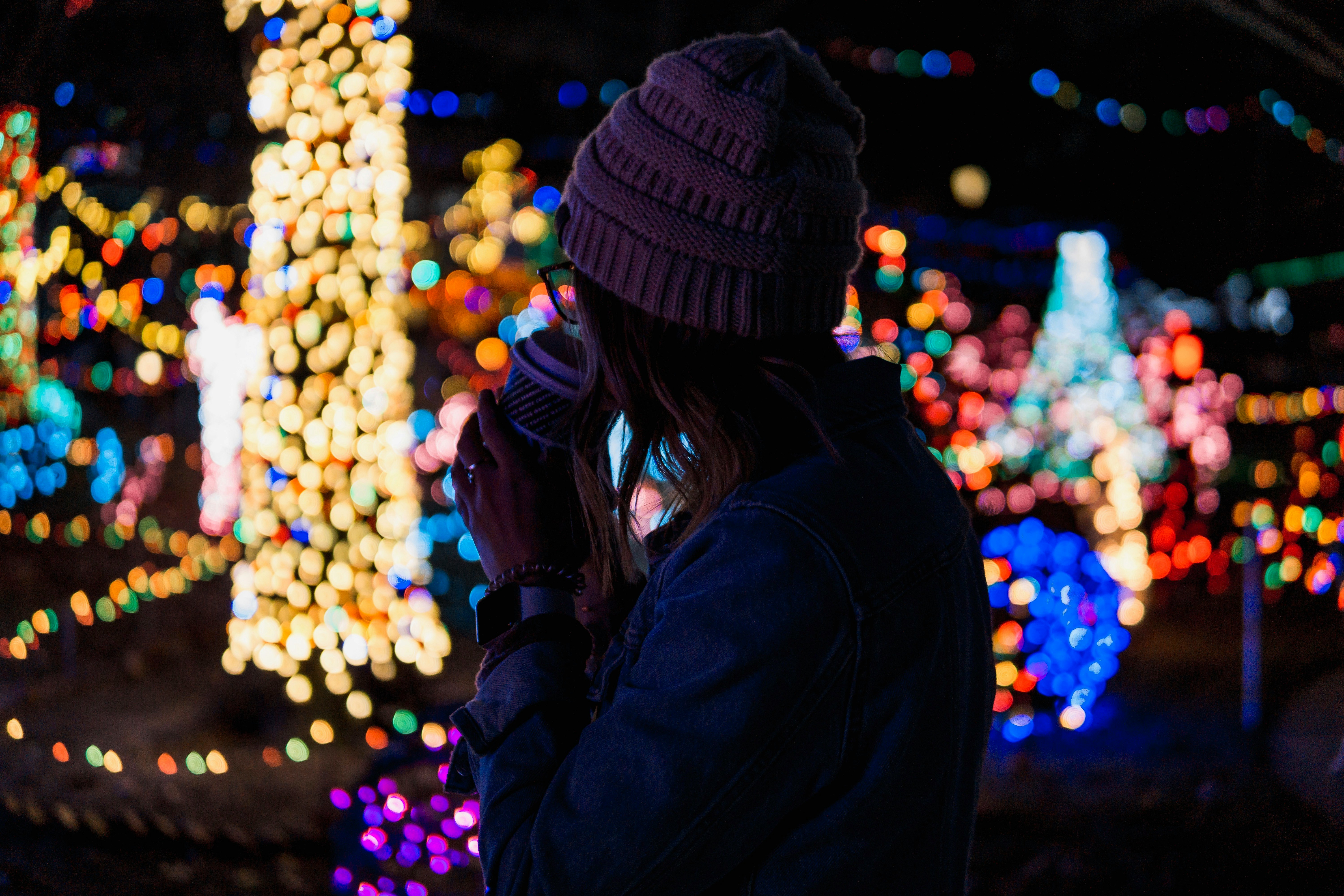 bokeh photography of woman near lights